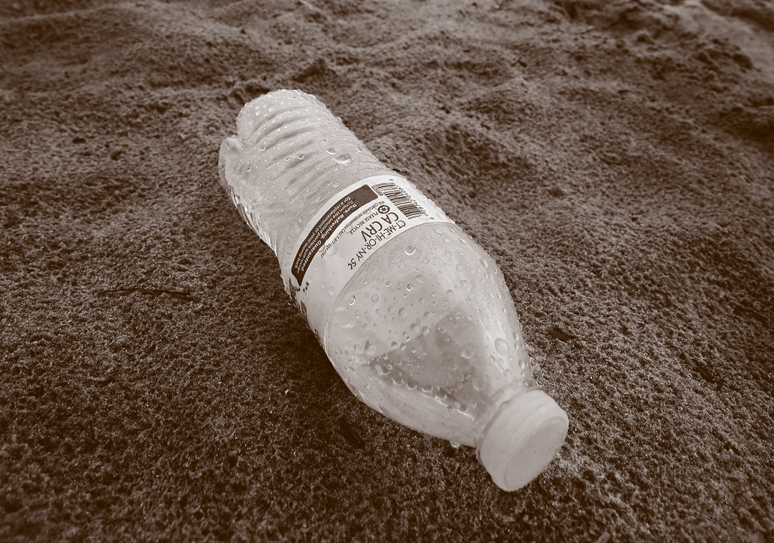 Plastic bottle on beach.