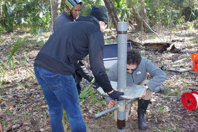 A group of people set up a monitoring station.
